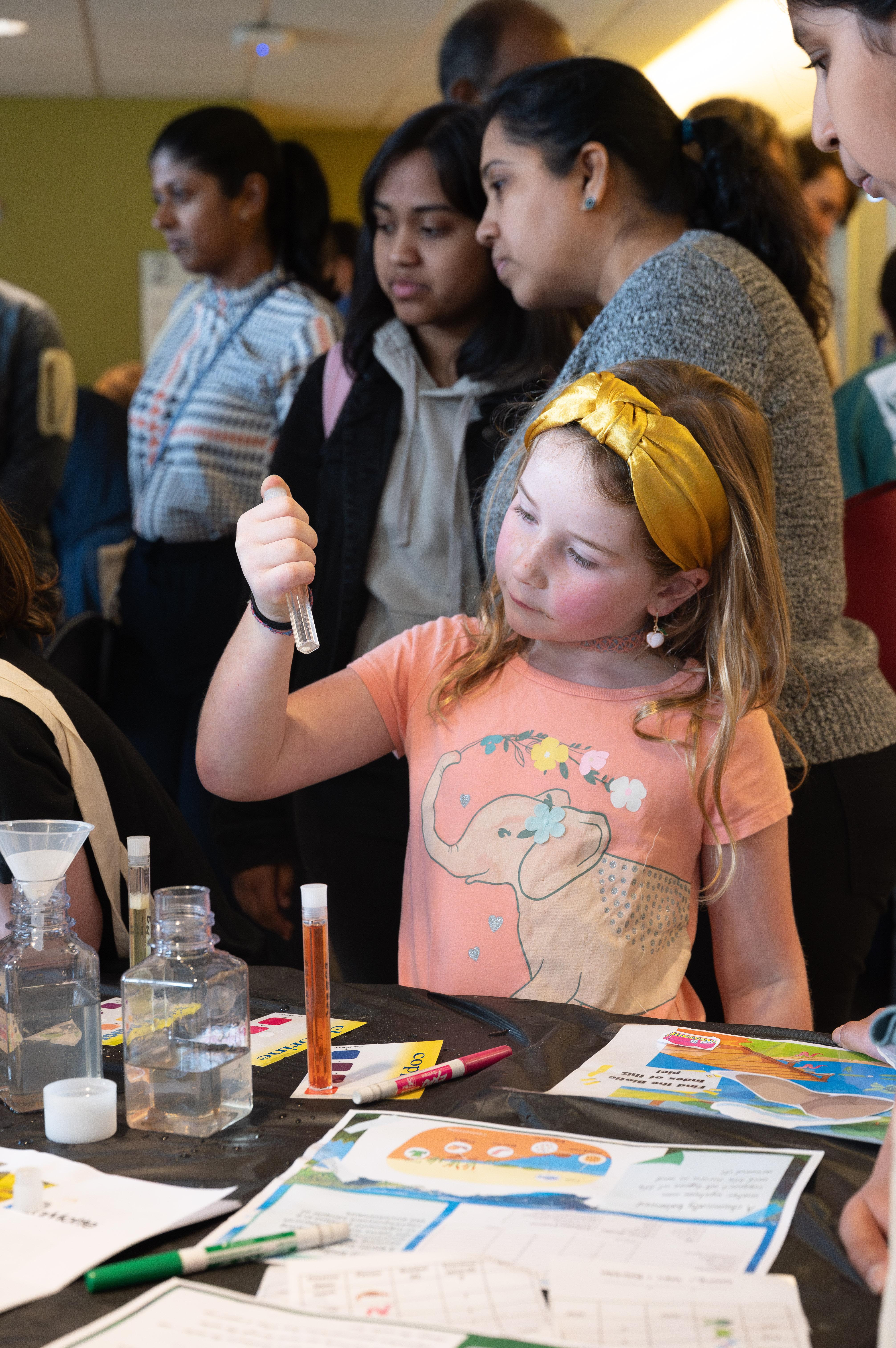 This guest at Science and Engineering Day examines tiny living organisms in a test tube. (Credit: Joya Chapman) This guest at Science and Engineering Day examines tiny living organisms in a test tube. (Credit: Joya Chapman)