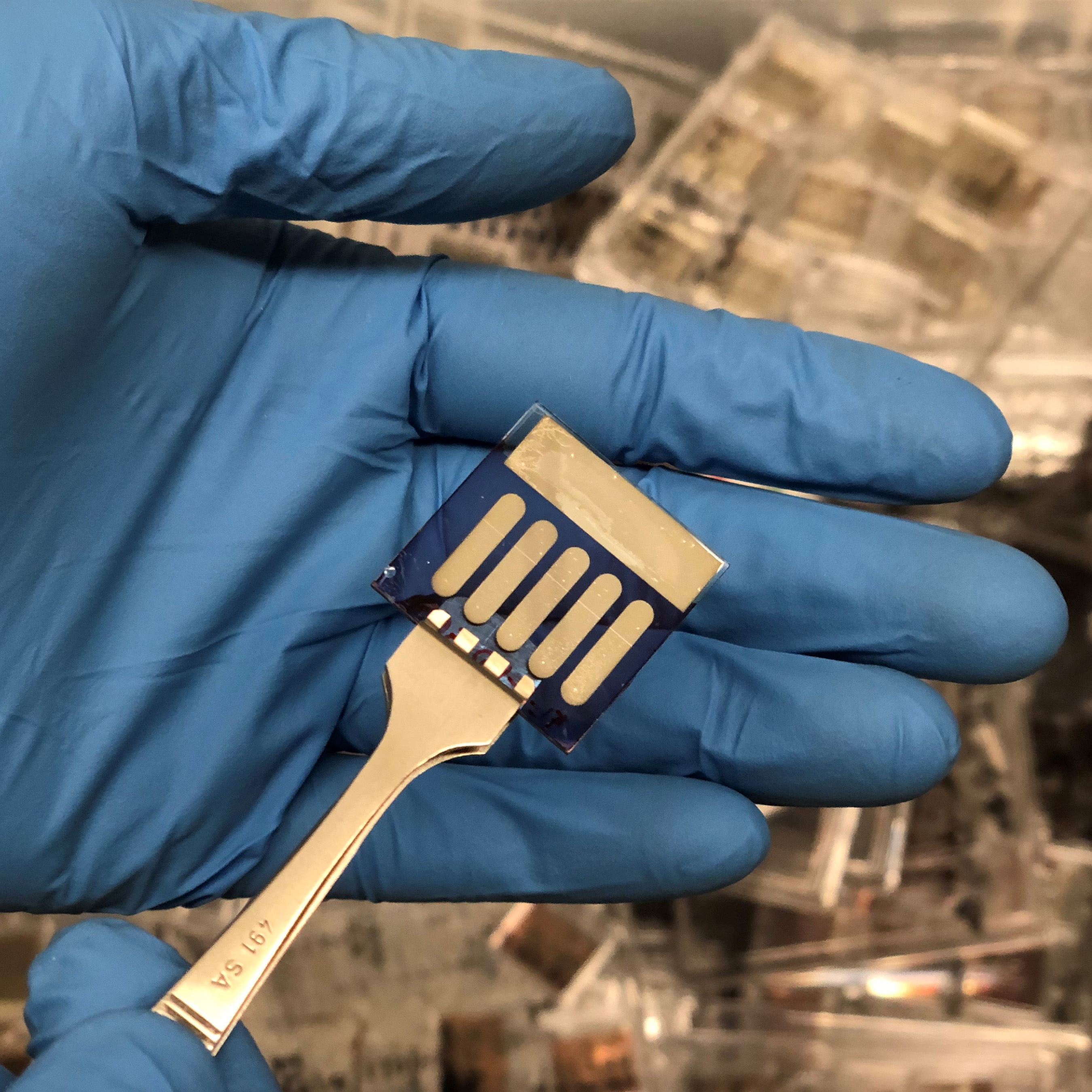 This sample includes five small area organic photovoltaic devices that were fabricated in the Kippelen Research Group at Georgia Tech. Samples with similar geometry were sent to the ISS to investigate the effects of exposure to space environments. (Photo: Bernard Kippelen, Georgia Tech) This sample includes five small area organic photovoltaic devices that were fabricated in the Kippelen Research Group at Georgia Tech. Samples with similar geometry were sent to the ISS to investigate the effects of exposure to space environments. (Photo: Bernard Kippelen, Georgia Tech)