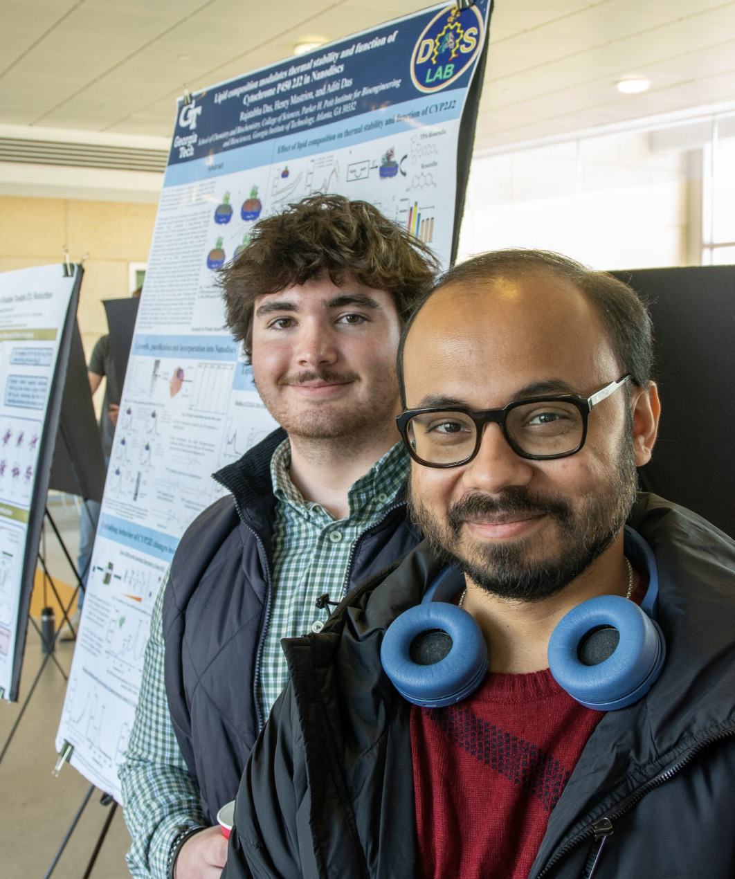 An undergraduate and graduate student with their poster.